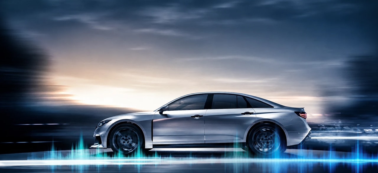 Silver EV sedan with sound wave graphics, representing a quiet cabin